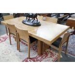 Heals; a modern figured oak rectangular dining table on a pair of slab supports,