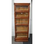 Globe Wernicke; a narrow oak five section bookcase with bevelled glazed doors,
