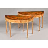 A pair of George III style demi-lune console tables,