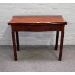 A mid-18th century mahogany tea table, the foldover serpentine top on canted square supports,