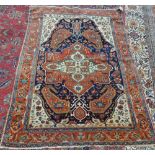 A Fereghan rug, Persian, the dark indigo field with a bold madder medallion with large boteh ends,