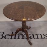 An 18th century oak circular snap top tripod occasional table, diameter 73cm, 69cm high.