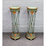 A pair of 18th century style parcel gilt green painted circular torchere stands with open metal