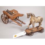 A 19th century painted wooden model of a horse, 20cm wide x 20cm high, a later associated cart,