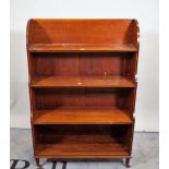 A Victorian mahogany and ebony inlaid four tier waterfall open bookcase on turned supports,
