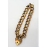 A gold hollow curb link bracelet, detailed 9 C, on a gold heart shaped padlock clasp, detailed 9 CT,