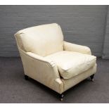A cream leather faux crocodile skin upholstered easy armchair on turned ebonised supports,