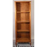 A 20th century stained beech floor standing open bookcase on cabriole supports,