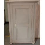 A late Victorian grey painted side cupboard with panelled doors, on bun feet,