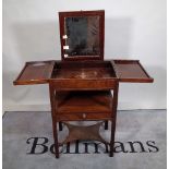 A George III mahogany lift top wash stand with pop-up mirror and single drawer,