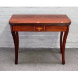 A Regency style inlaid mahogany card table, the rounded rectangular top on sabre supports,