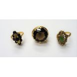 A gold ring, claw set with a circular cut smoky quartz,