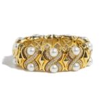 An Italian gold, diamond set and cultured pearl sprung bangle,