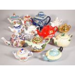 A quantity of 20th century novelty teapots including, Sadler, a Ringtons blue and white teapot,