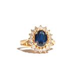 A gold, sapphire and diamond oval cluster ring,