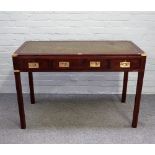 A campaign style brass bound mahogany three draw writing desk, on channelled square supports,