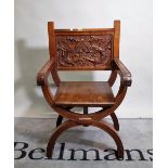 A 19th century Continental walnut 'X' frame open armchair with carved opposing griffin back,