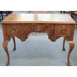 A Queen Anne style figured walnut low boy, with three frieze drawers on cabriole supports,