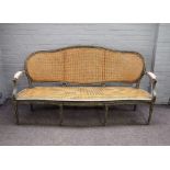 A Louis XVI style open arm sofa with distressed green/ grey painted frame and serpentine seat,
