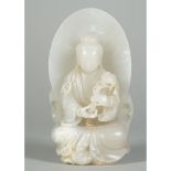 A Chinese white jade figure of Guanyin, Qing dynasty, the goddess seated before an oval mandorla,