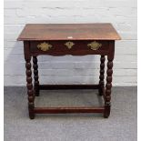 A 17th century oak side table with single frieze drawer on bobbin turned supports,