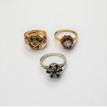 A 9ct gold and diamond set three stone ring, in an interwoven knot shaped design,
