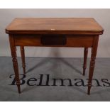 A Victorian mahogany tea table on turned supports, 91cm wide x 77cm high.