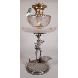 An early 20th century silver plated and glass oil lamp,