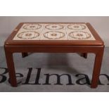 A 20th century teak rectangular coffee table with inset six tile top, 71cm wide x 41cm high.