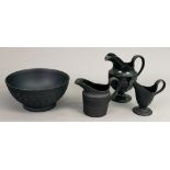A group of black basalt teawares, 20th century, comprising: an engine turned bowl,