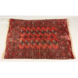 An Afgan Bokhara rug, with two rows of quartered guls on a rust ground, 176 x 125cm,
