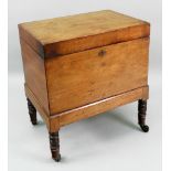 A George III rectangular mahogany cellarette, with hinged top, on ring turned legs and castors,