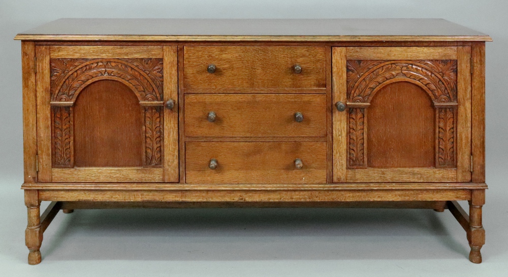 A reproduction carved oak sideboard, in late 17th century style,