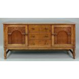 A reproduction carved oak sideboard, in late 17th century style,