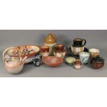 A collection of Studio ceramics including a teapot, a large circular plate and other items,