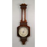 A mahogany cased barometer thermometer, circa 1915, blind fret carved, 87cm high,