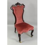 A Victorian mahogany side chair, of shaped outline, with upholstered back and seat,