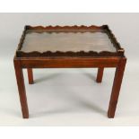 A George III rectangular mahogany tray, with wavy gallery,