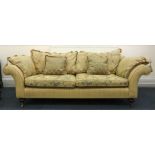 A large reproduction Victorian style upholstered sofa, with scroll arms,