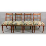 A set of four Edwardian oak dining chairs, with bar backs, on ring turned legs,