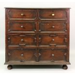 A reproduction Charles II style oak chest, fitted with two short and three long drawers,