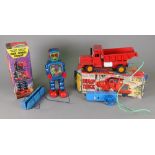 A tin plate battery operated remote control dump truck and a KO battery operated remote control