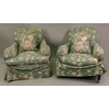 A pair of early 20th century upholstered deep seated armchairs,