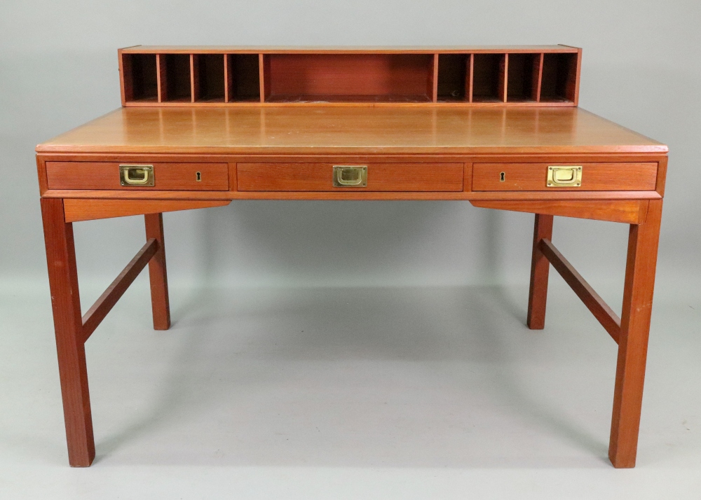 A retro teak Military style desk, circa 1970's, with a low raised back fitted with pigeon holes,