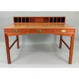 A retro teak Military style desk, circa 1970's, with a low raised back fitted with pigeon holes,