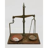 A set of late Victorian brass beam scales, W & T Avery Ltd to weigh 7 lb, on a wooden base,