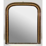A Victorian arched moulded walnut and gilt gesso frame overmantel mirror, 109cm wide x 127cm high.