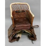 A child's Victorian wicker donkey seat, with leather cushion and straps, 35cm wide x 52cm high.