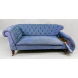 A late Victorian button down upholstered Chesterfield settee, with drop ends, in blue material,