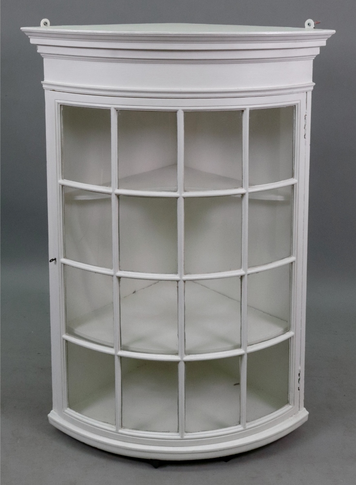 A George III style white painted bowfronted wall hanging corner cabinet with glazed door, 91cm high.